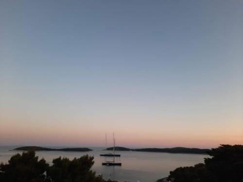 a group of boats in the water at sunset at Villa Malisko in Hvar
