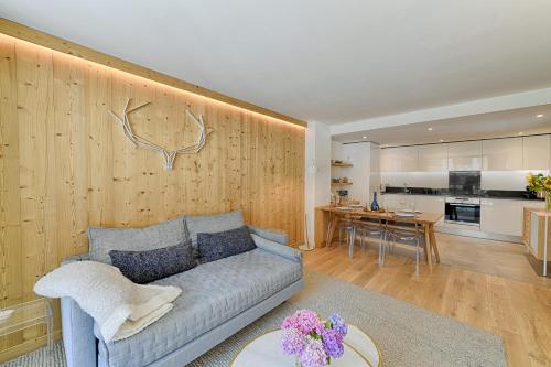 a living room with a couch and a kitchen at Thedrus luxury apt, swimming pool, SPA & more in Chamonix-Mont-Blanc