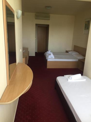 a hotel room with two beds and a table at CT Tm in Timişoara