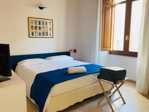 a bedroom with a bed with a suitcase on it at NG Guest House il RIS in Sassari