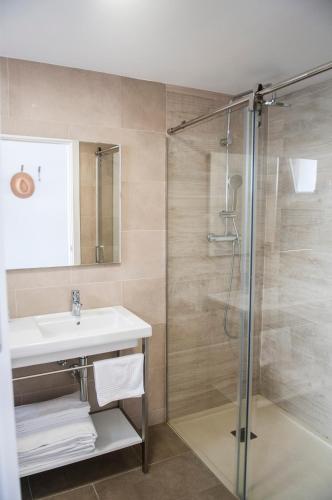 a bathroom with a sink and a shower at Naranjos Resort Menorca in S'Algar