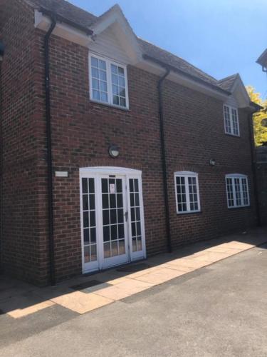 a brick building with a white door and windows at The Swan Hotel, Alresford in Winchester