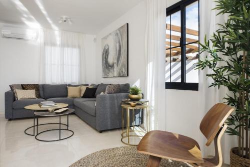 a living room with a couch and a table at Villa Abeto in Yaiza