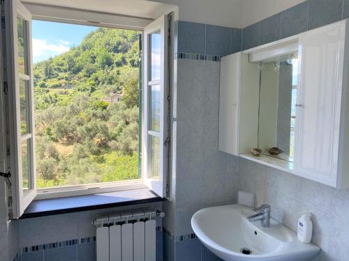 a bathroom with a sink and a window at Le case della Lizza - Casa Rossa in Levanto