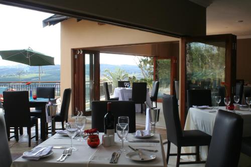 a dining room with tables and chairs with wine glasses at Destiny Lodge in White River