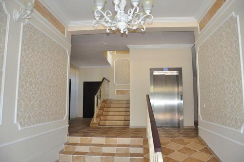 a hallway with a chandelier and stairs in a building at Apartment Studio New York 45 in Irpin'