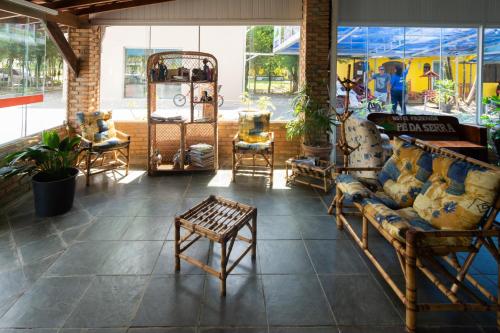 a room with couches and chairs in a store at Hotel Fazenda Pé da Serra in Bom Sucesso
