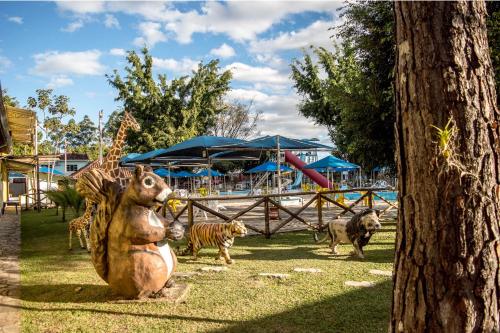 a statue of a bear and animals in a park at Hotel Fazenda Pé da Serra in Bom Sucesso