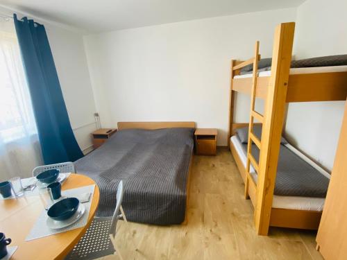 a small room with a desk and bunk beds at Relax in Ostrowo