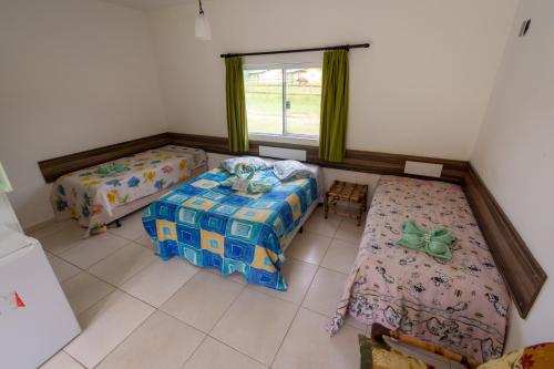 A bed or beds in a room at Hotel Fazenda Pé da Serra
