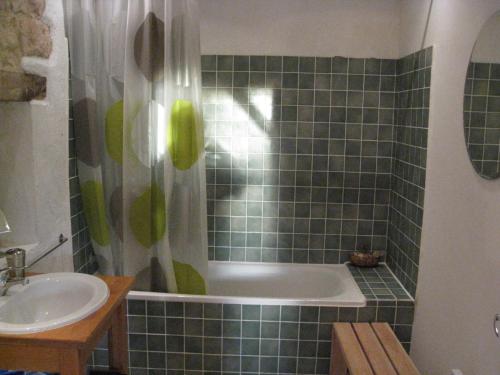 une salle de bain avec une baignoire et un lavabo dans l'établissement La Grange, à Vanzay