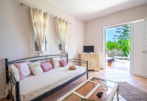 a living room with a couch and a glass table at Alavastros Maisonettes Near 3 sandy beaches in Vasilikos