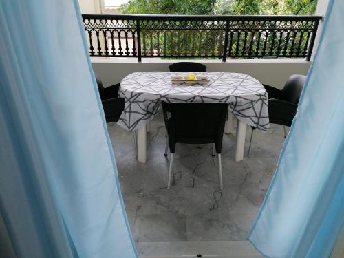 a table and chairs sitting on a balcony at 85 sqm Apartments New Panorama ELECTRIC CAR ΦΩΡΤΗΣΗΣ STATION in Paralion astros