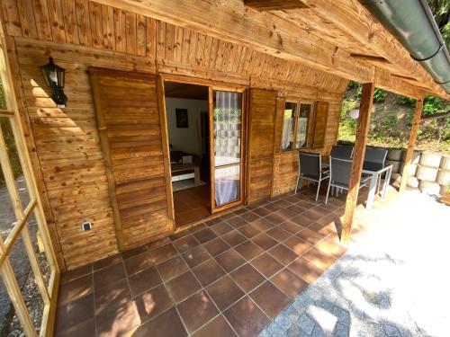 an outside view of a wooden cabin with a patio at NEU! Chalet Ilztal in Hutthurm