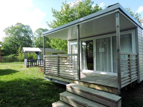 a screened in porch on a house with a gazebo at Camping de l'Ill in Mulhouse