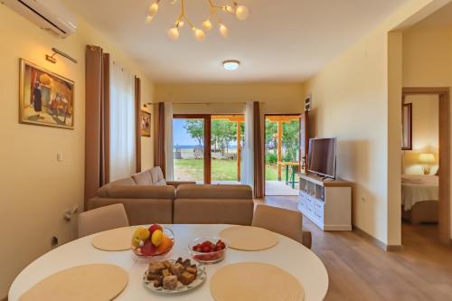 a living room with a couch and a table with fruit on it at Holiday Home Sea in Petrovac na Moru