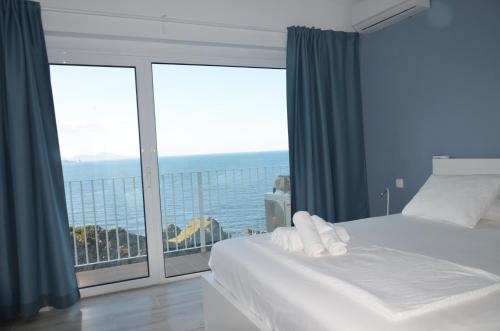 a bedroom with a bed and a large window at Cap Sa Sal - Sa Roca 2 in Begur