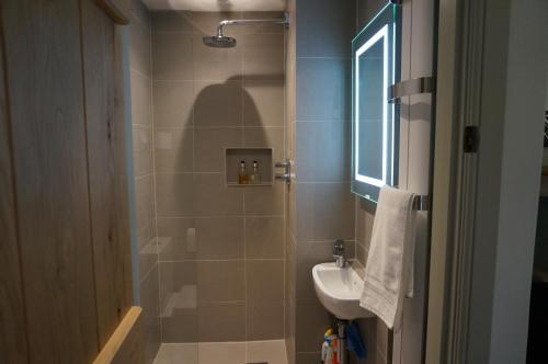 a bathroom with a sink and a toilet and a shower at Gatekeepers Lodge, Dyrham Park - Private & Self Contained, deluxe accommodation, 15 mins from Bath in Dyrham