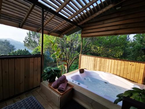 a jacuzzi tub in a room with a large window at CABAÑAS MONTEVERDE - Guarne ANT in Guarne