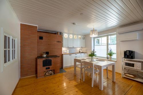a kitchen with a table and a brick wall at Kuressaare Turu Apartment in Kuressaare