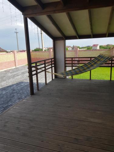 a porch with a hammock on a boardwalk at Scandidim Lutsk in Luts'k