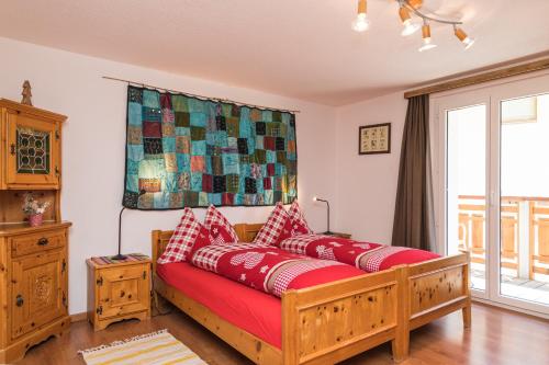 a couch with red pillows in a living room at BaseCamp Apartments in Zermatt