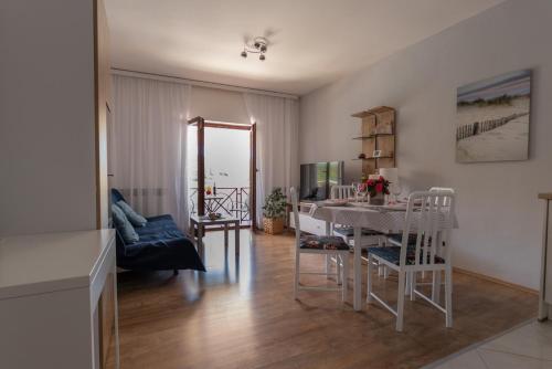 a dining room and living room with a table and chairs at Apartment Blašković in Novigrad Dalmatia