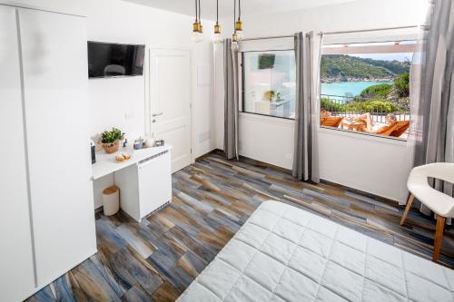 a room with a view of the ocean at B&B La Torre Elite in Santa Teresa Gallura