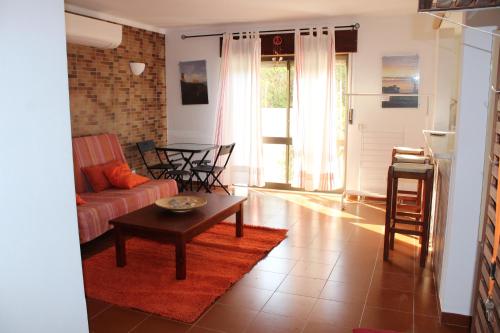 a living room with a couch and a table at Beach front apartment 1 in Sagres