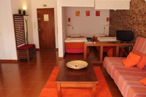 a living room with a couch and a table at Beach front apartment 1 in Sagres