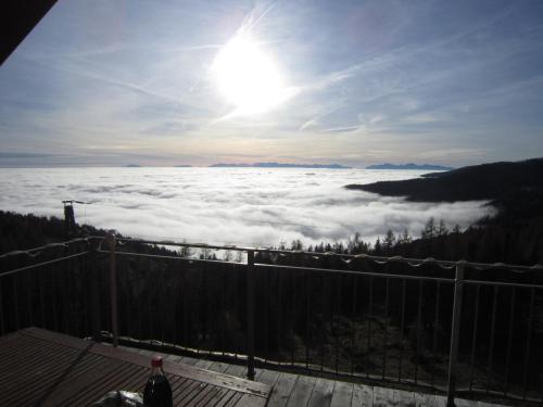 a view of the sun above a sea of clouds at Almhaus Karantanien in Hochrindl