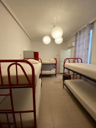 a room with several bunk beds and a room with at Barbieri Sol Hostel in Madrid