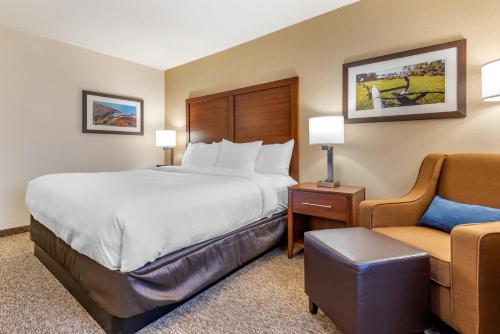 a hotel room with a bed and a chair at Comfort Inn & Suites in Goderich