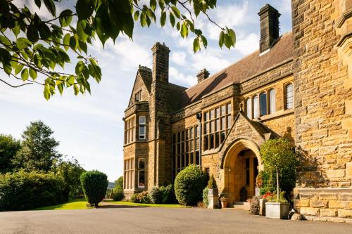 an old brick building with a driveway at The Wrea Head Hall Country House Hotel & Restaurant in Scarborough