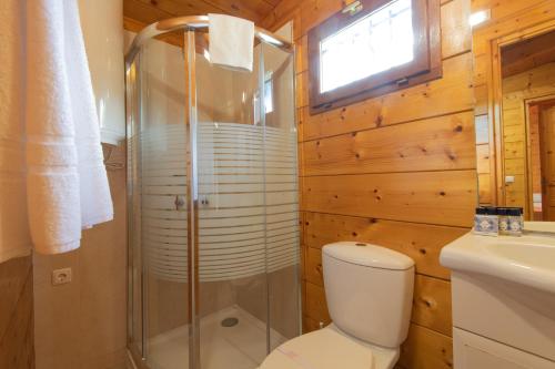 a bathroom with a shower and a toilet and a sink at Herdade do Sardanito da Frente in Zambujeira do Mar