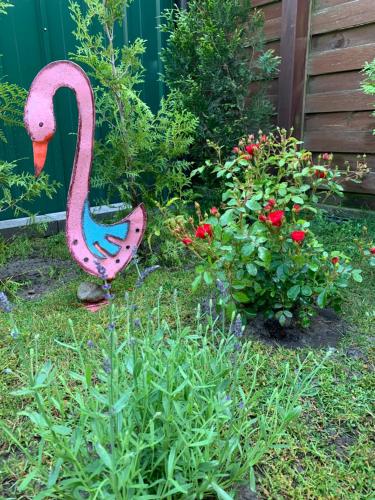 a colorful statue of a swan in a garden at 4 All Apart Hotel in Swarzędz