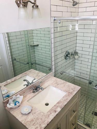 a bathroom with a sink and a glass shower at The Palms Hotel in Key West