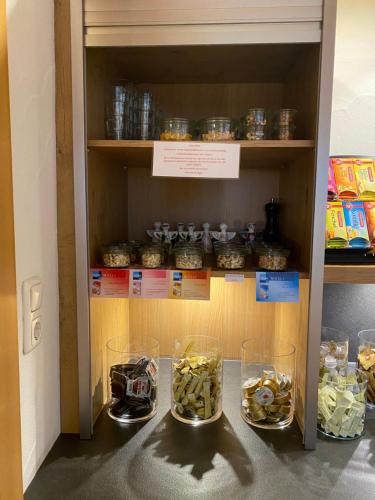 a cabinet with three glasses of food in it at Hotel Engel in Oberstdorf