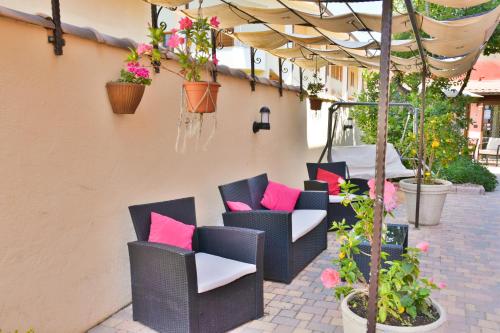 a row of colorful umbrellas sitting on top of a patio at Flowery Inn Villa in Alghero