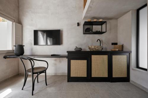a dining room with a table and a chair at Marillia Village in Perivolos