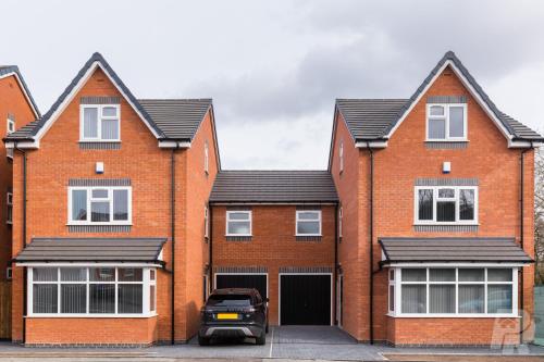 a brick house with a car parked in front of it at Birmingham Estate - Contractor & Group Accommodation - Secure Parking in Birmingham