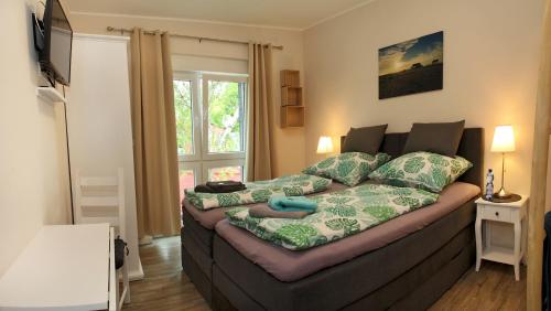 a living room with a couch with a bed at Sportpension "Seminarhaus an der Eider" in Tönning