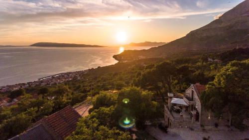 an aerial view of the sun setting over the ocean at Ivićev san in Tučepi