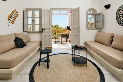 a living room with two couches and a table at Marillia Village in Perivolos