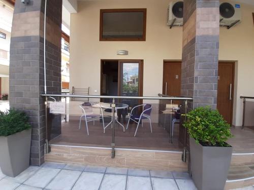 a balcony with chairs and a table in a building at Levantes in Asprovalta