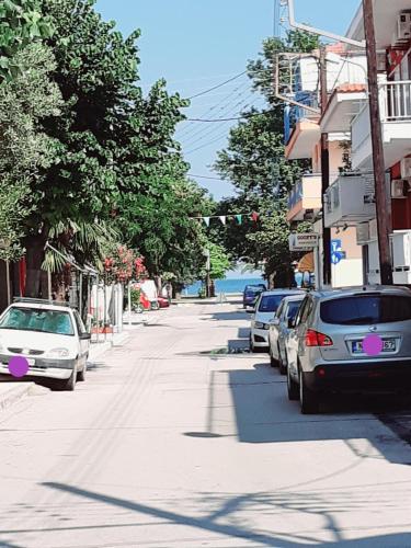 a street with cars parked on the side of the road at Levantes in Asprovalta