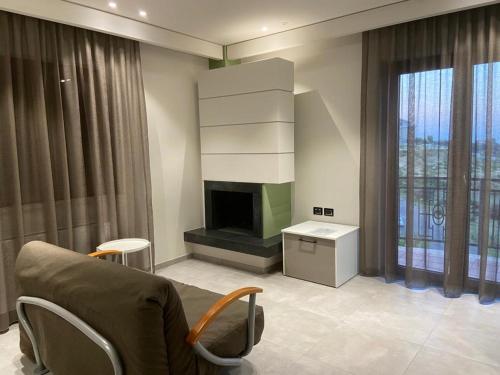 a living room with a couch and a fireplace at Villa Torre degli Ulivi in Corigliano Calabro