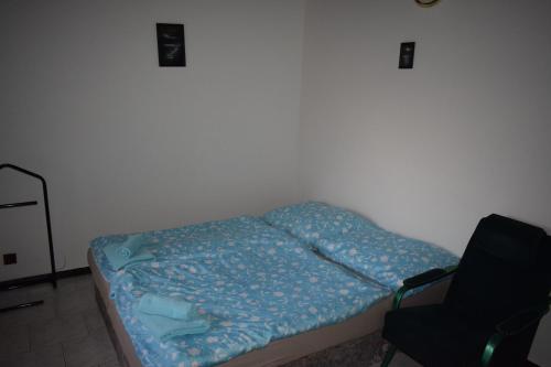 Radějov的住宿－Penzion RONY，一张小床,位于带椅子的房间里