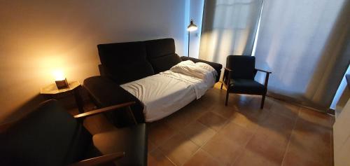 mała sypialnia z łóżkiem i krzesłem w obiekcie Golf & Beach La Alcaidesa Terrace w mieście San Roque