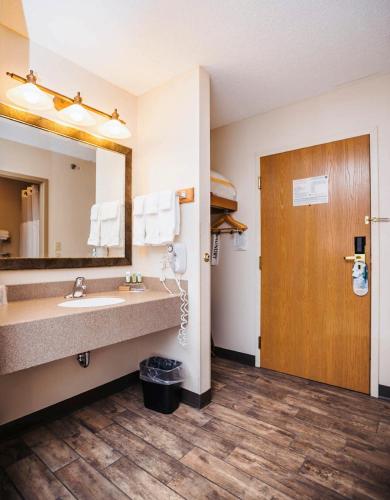 a bathroom with a sink and a large mirror at SureStay Plus Hotel by Best Western Elizabethtown Hershey in Elizabethtown